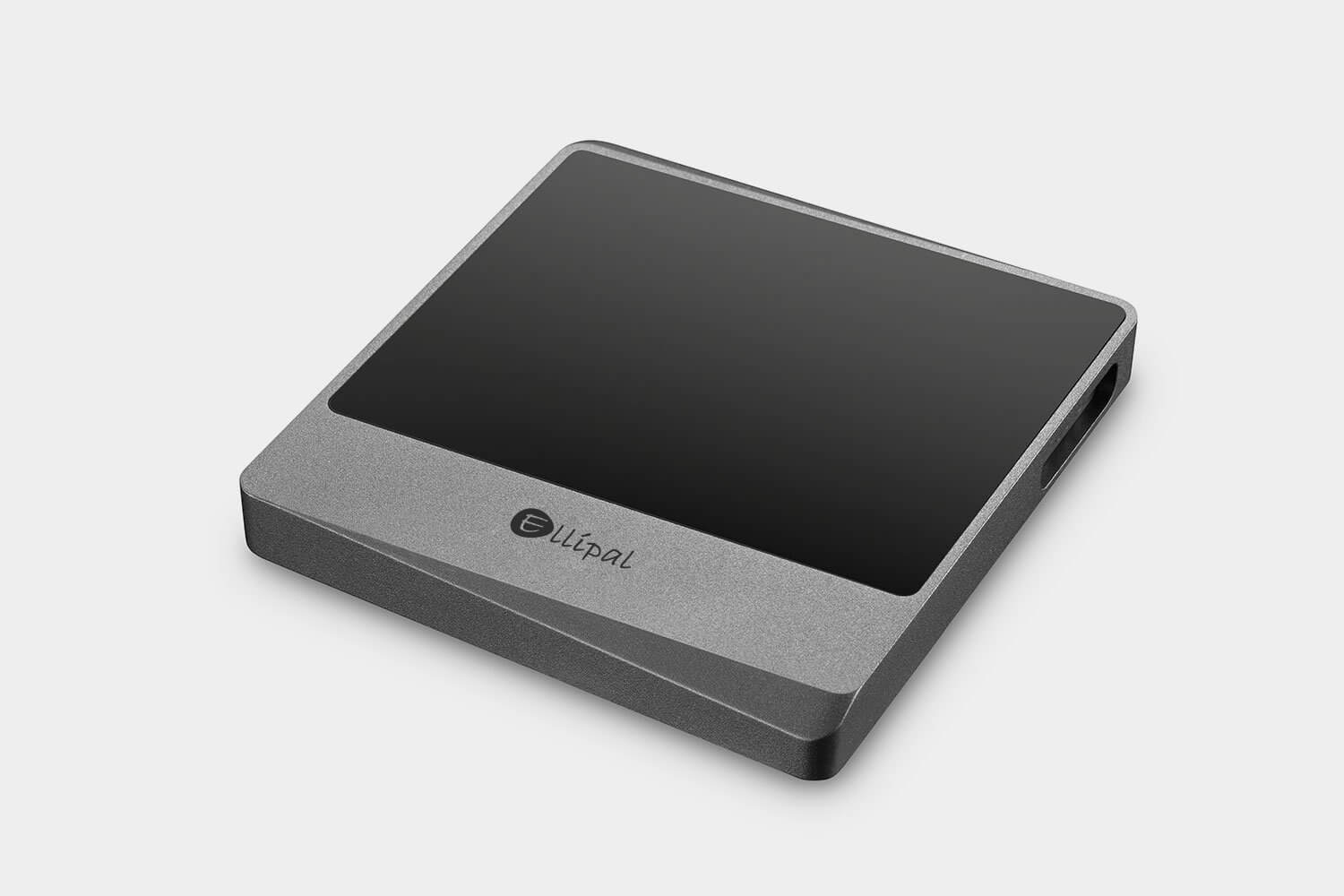 ELLIPAL Titan Mini hardware wallet lying face up on a white desk, with its screen turned off.