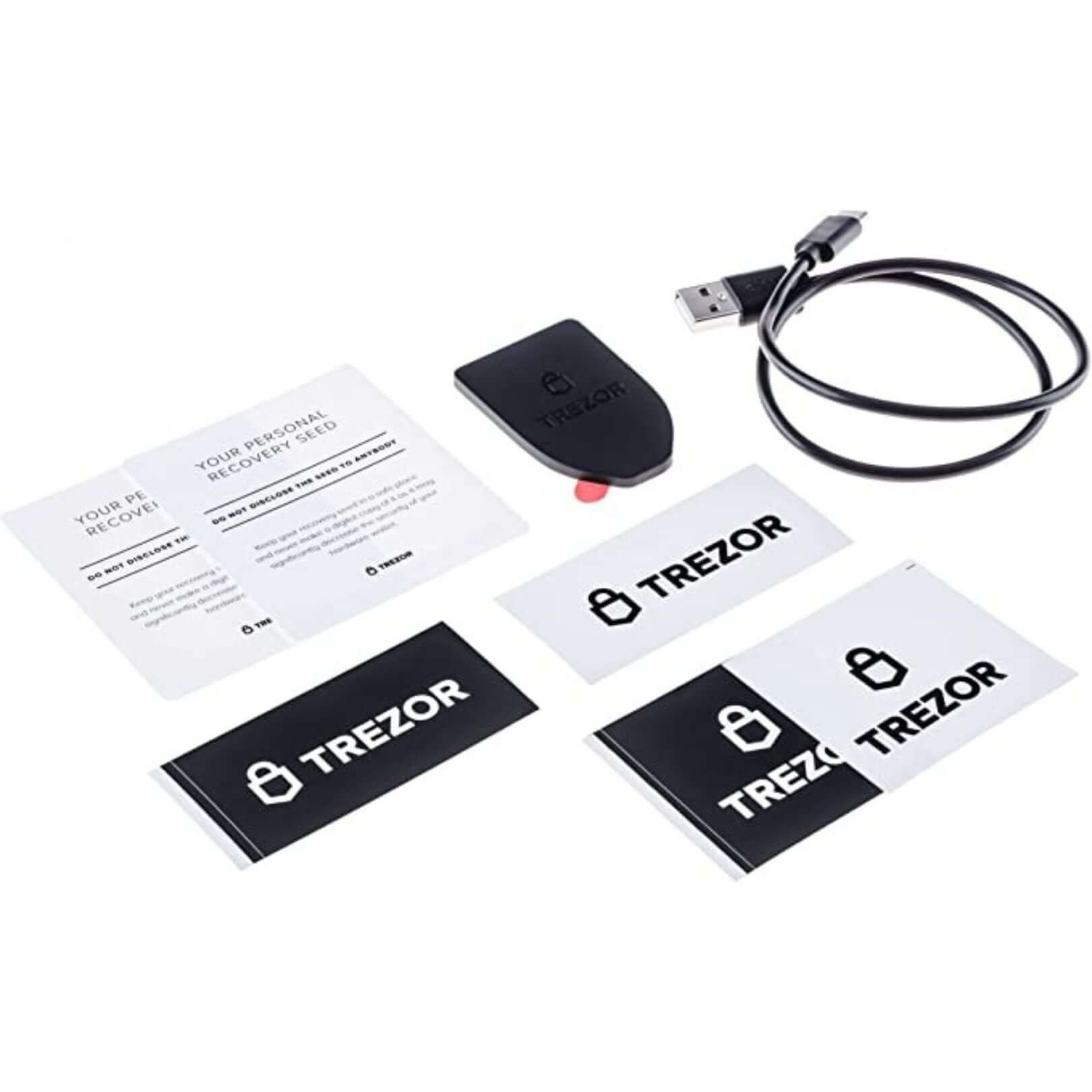 The Trezor Model T crypto hardware wallet is shown unboxed on a white background alongside the accompanying items that come in the box..